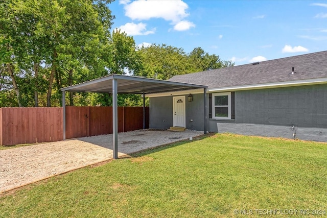 exterior space with a carport and a yard