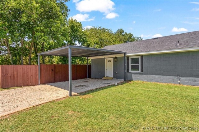 701 W Alabama, Durant, OK 74701 - view of patio with a detached carport, fence, and driveway