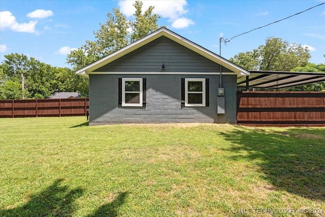 rear view of property featuring a yard