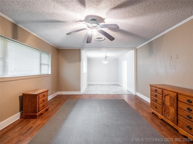 unfurnished room featuring crown molding, hardwood / wood-style floors, and ceiling fan