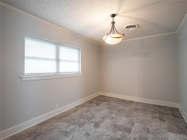 spare room with a textured ceiling and ornamental molding