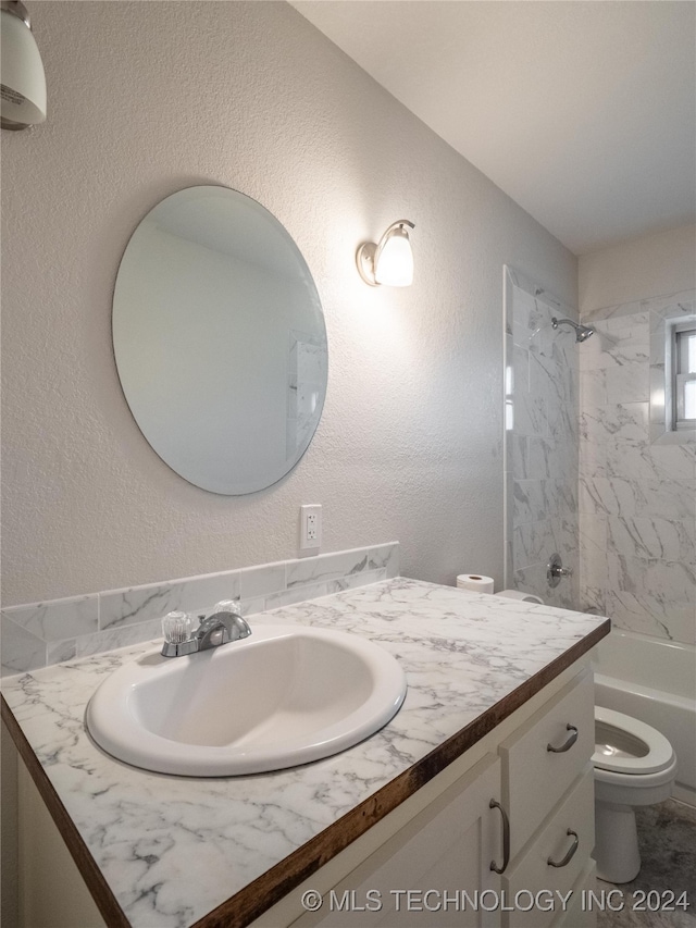 full bathroom with vanity, toilet, and tiled shower / bath