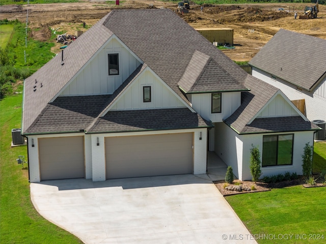 view of front of property with a garage and a front lawn