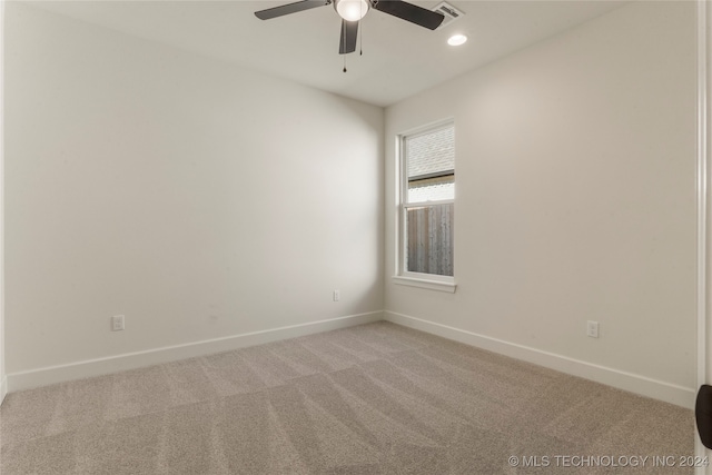 carpeted spare room with ceiling fan