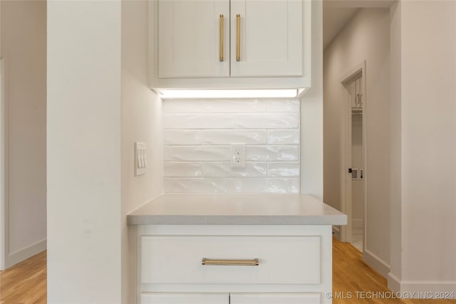 kitchen featuring light hardwood / wood-style flooring and white cabinets