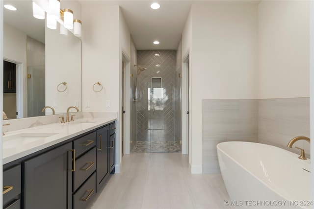 bathroom with plus walk in shower, dual bowl vanity, and tile patterned floors