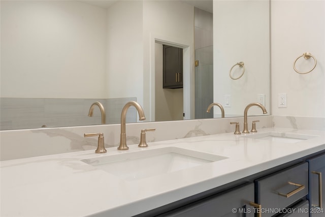 bathroom with double sink vanity and a bathing tub