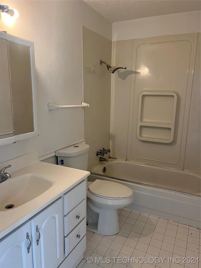 full bathroom with a textured ceiling, vanity, tile patterned flooring, toilet, and washtub / shower combination