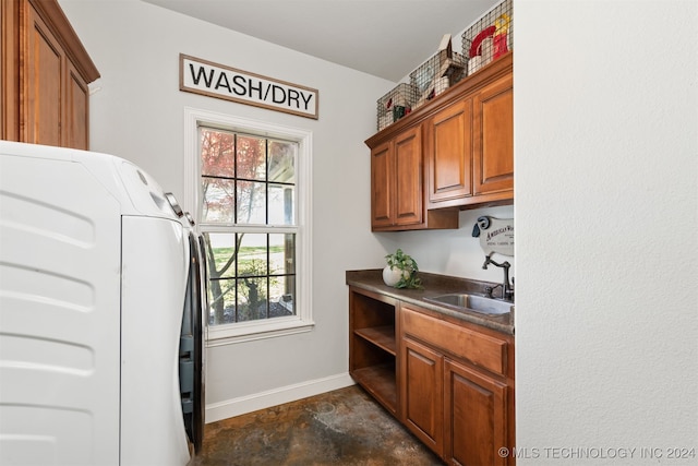 laundry room with washing machine and dryer, sink, and cabinets