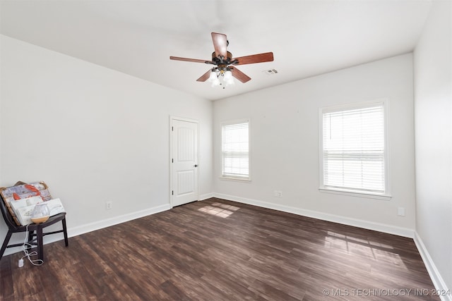 spare room with ceiling fan and dark hardwood / wood-style floors