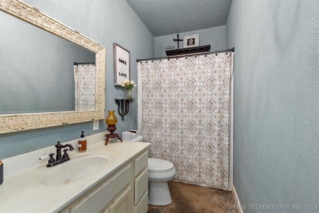 bathroom with vanity, toilet, and a textured ceiling