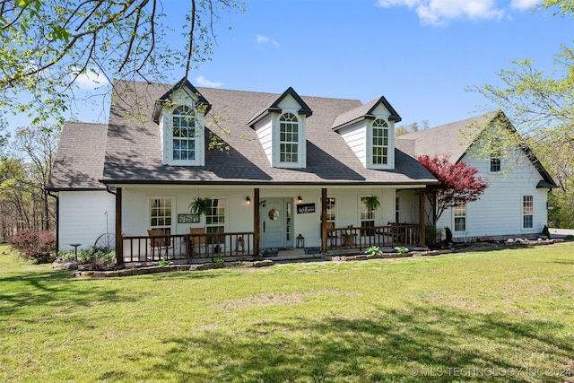 cape cod home featuring a front lawn and covered porch