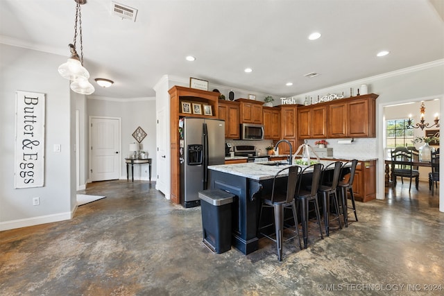 kitchen featuring a kitchen breakfast bar, light stone counters, a kitchen island with sink, appliances with stainless steel finishes, and ornamental molding