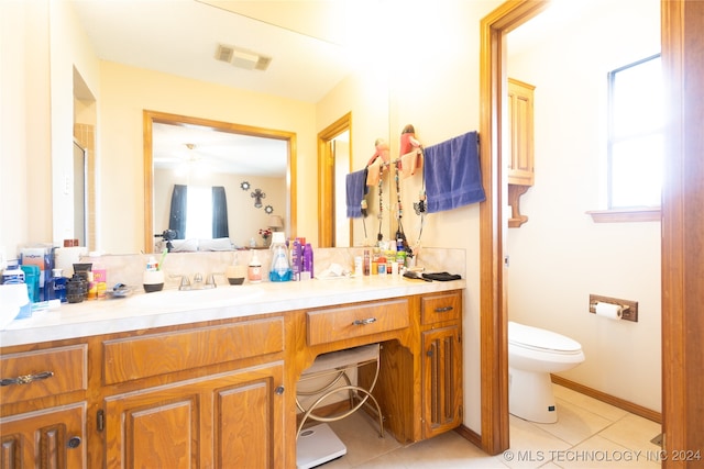 bathroom featuring toilet, vanity, and tile patterned floors