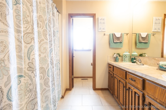 bathroom with tile patterned floors and vanity