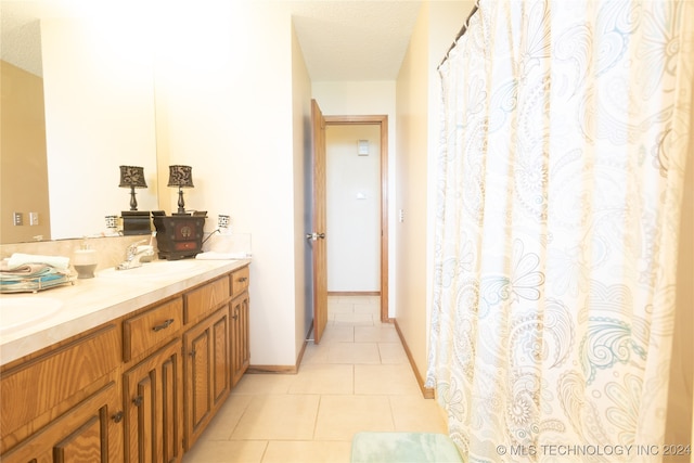 bathroom featuring double vanity and tile patterned flooring