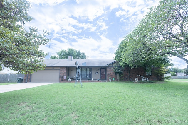 ranch-style home with a front yard and a garage