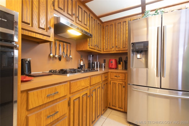 kitchen featuring light tile patterned floors and stainless steel appliances