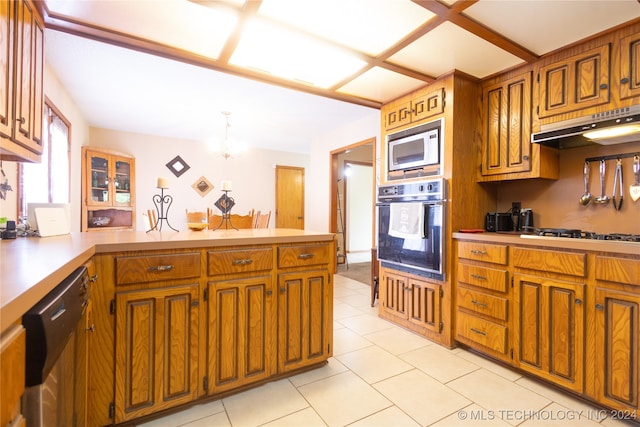 kitchen featuring kitchen peninsula, stainless steel appliances, and light tile patterned flooring