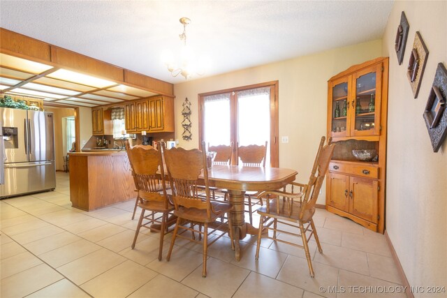 dining space featuring a chandelier and light tile patterned floors