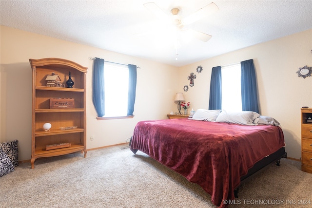 carpeted bedroom with a textured ceiling and ceiling fan