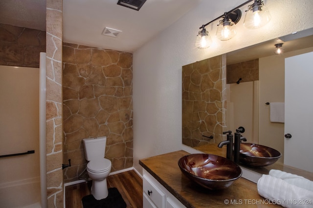 bathroom featuring vanity, wood-type flooring, and toilet