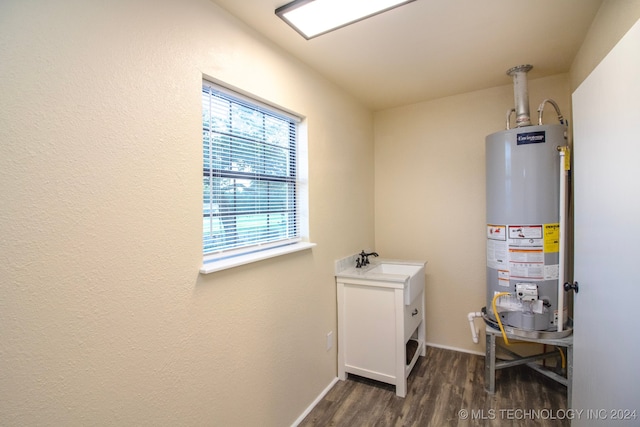 utility room with sink and water heater