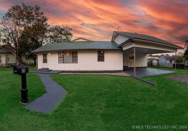 ranch-style house with fence, an attached carport, metal roof, and a front yard