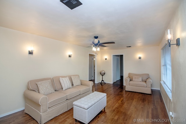 living area featuring baseboards, a ceiling fan, wood finished floors, and visible vents
