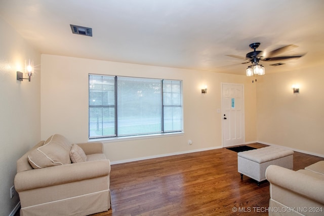 living room featuring dark hardwood / wood-style floors and ceiling fan