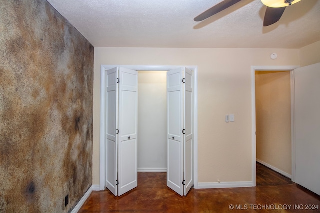 unfurnished bedroom with a textured ceiling and ceiling fan