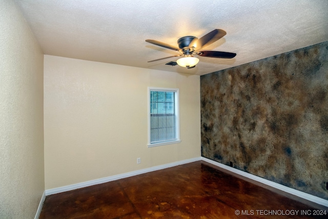 spare room featuring a textured ceiling and ceiling fan