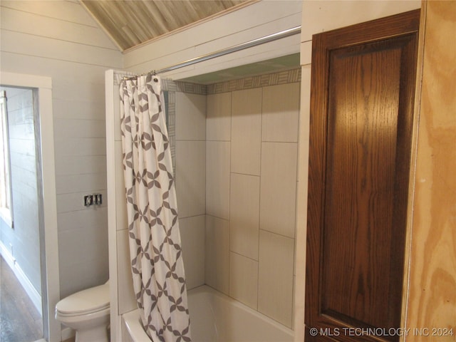 bathroom featuring wood-type flooring, toilet, shower / bathtub combination with curtain, and lofted ceiling