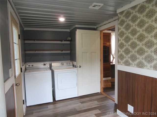 laundry room with independent washer and dryer and hardwood / wood-style floors