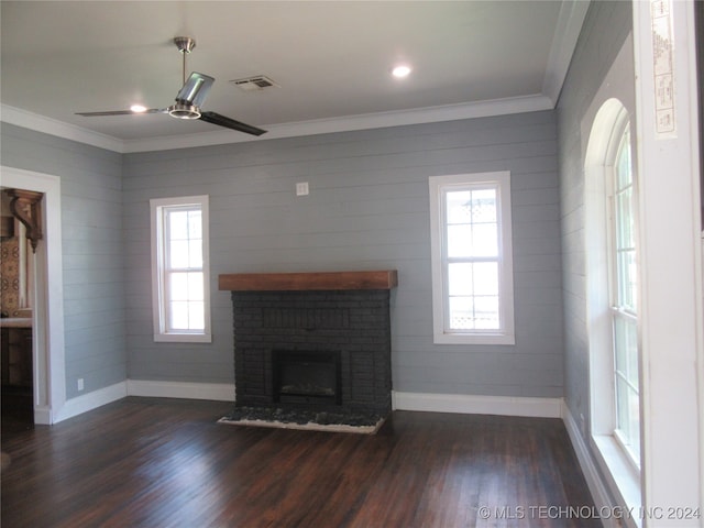 unfurnished living room featuring a fireplace, ceiling fan, dark wood-type flooring, and crown molding