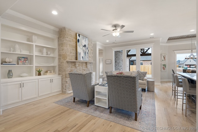 interior space with ceiling fan with notable chandelier, crown molding, and light hardwood / wood-style floors