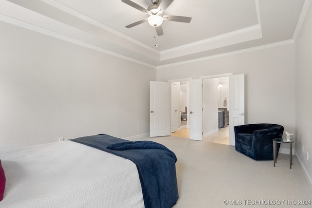 bedroom featuring crown molding, a raised ceiling, light tile patterned floors, ensuite bath, and ceiling fan