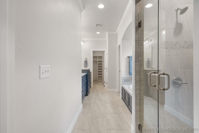 bathroom featuring crown molding, walk in shower, tile patterned floors, and vanity