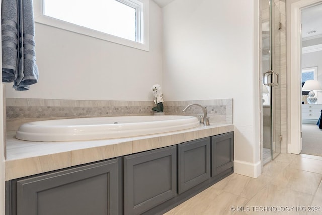 5424 E 125th Pl S, Bixby, OK 74008 - full bathroom with healthy amount of natural light, a shower stall, a bath, and baseboards