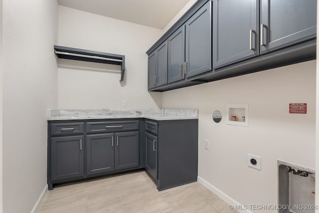 laundry room featuring washer hookup, electric dryer hookup, light tile patterned floors, and cabinets