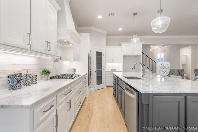 5424 E 125th Pl S, Bixby, OK 74008 - kitchen with a sink, stainless steel appliances, ornamental molding, white cabinets, and custom range hood