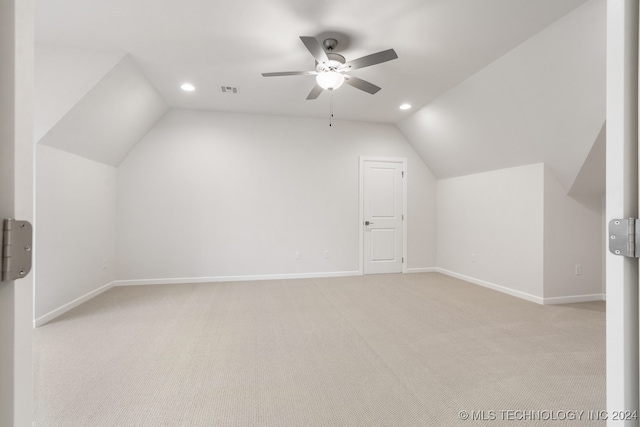 bonus room featuring ceiling fan, light carpet, and vaulted ceiling