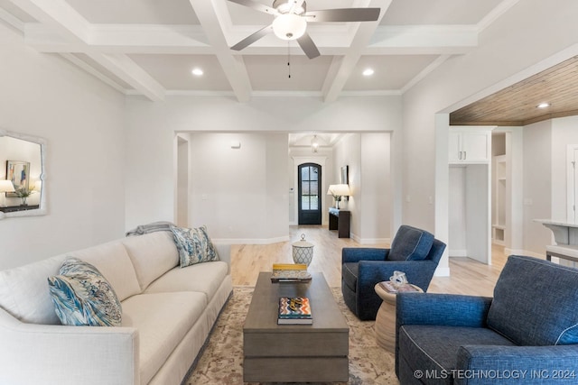 living room with ceiling fan, coffered ceiling, ornamental molding, light hardwood / wood-style floors, and beamed ceiling