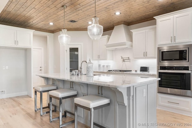 1734 W 115th Pl, Jenks, OK 74132 - kitchen featuring appliances with stainless steel finishes, custom range hood, wood ceiling, a sink, and white cabinetry