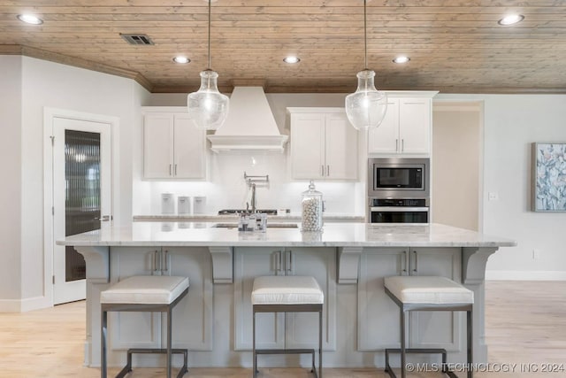 1734 W 115th Pl, Jenks, OK 74132 - kitchen featuring stainless steel appliances, custom range hood, wooden ceiling, white cabinets, and baseboards