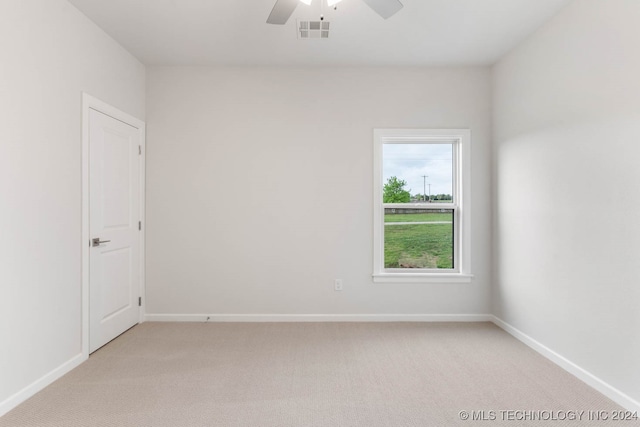 empty room with ceiling fan and light carpet