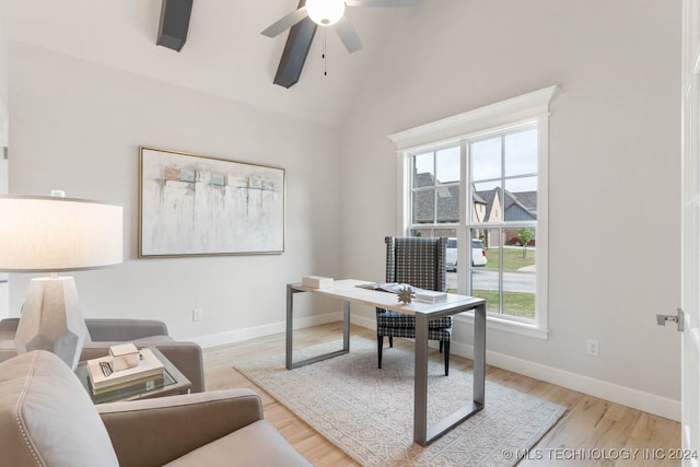 office space with ceiling fan, light hardwood / wood-style flooring, and lofted ceiling