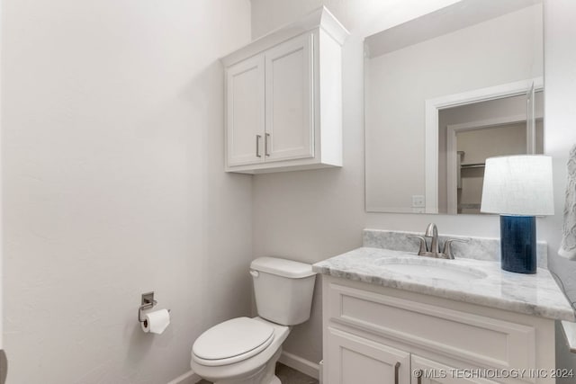 bathroom with toilet and vanity