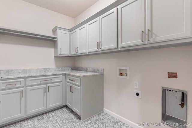1734 W 115th Pl, Jenks, OK 74132 - laundry area with cabinet space, hookup for an electric dryer, hookup for a washing machine, baseboards, and light tile patterned floors