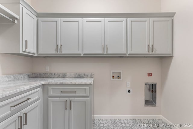 laundry room featuring hookup for an electric dryer, hookup for a washing machine, cabinets, and tile patterned floors